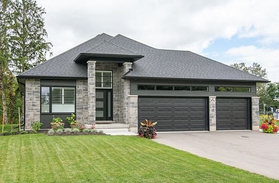 Bungalow with stone front and dark siding